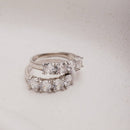 ANEL MEIA ALIANÇA QUATRO ZIRCÔNIAS REDONDAS RÓDIO BRANCO